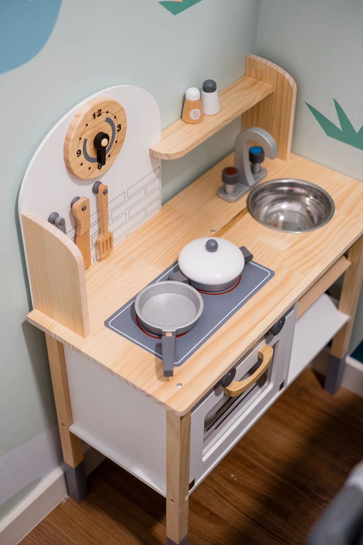 The wooden play kitchen in the kids' room