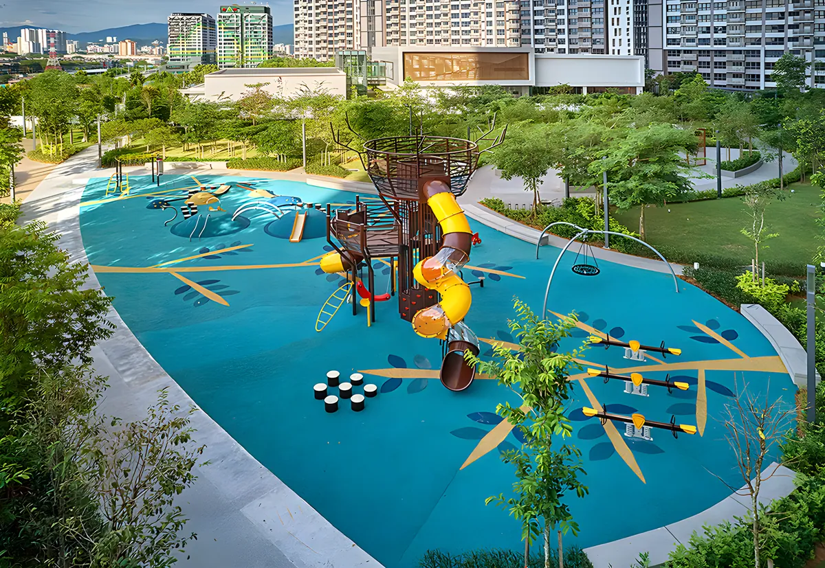 The residence playground from above: a treehouse tower with yellow twisty slides, play domes, stepping stones, a nest swing and see-saws on a blue play surface