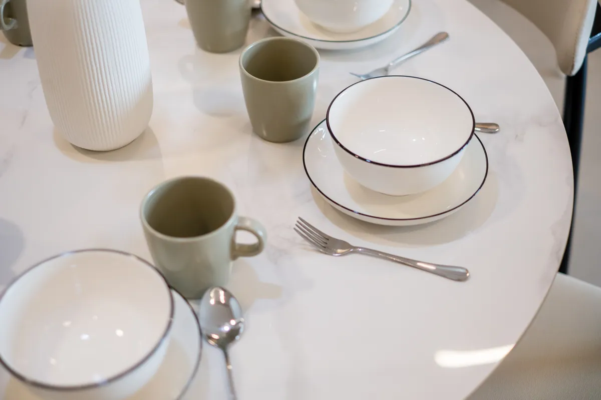 Plates, bowls and cups set on the dining table